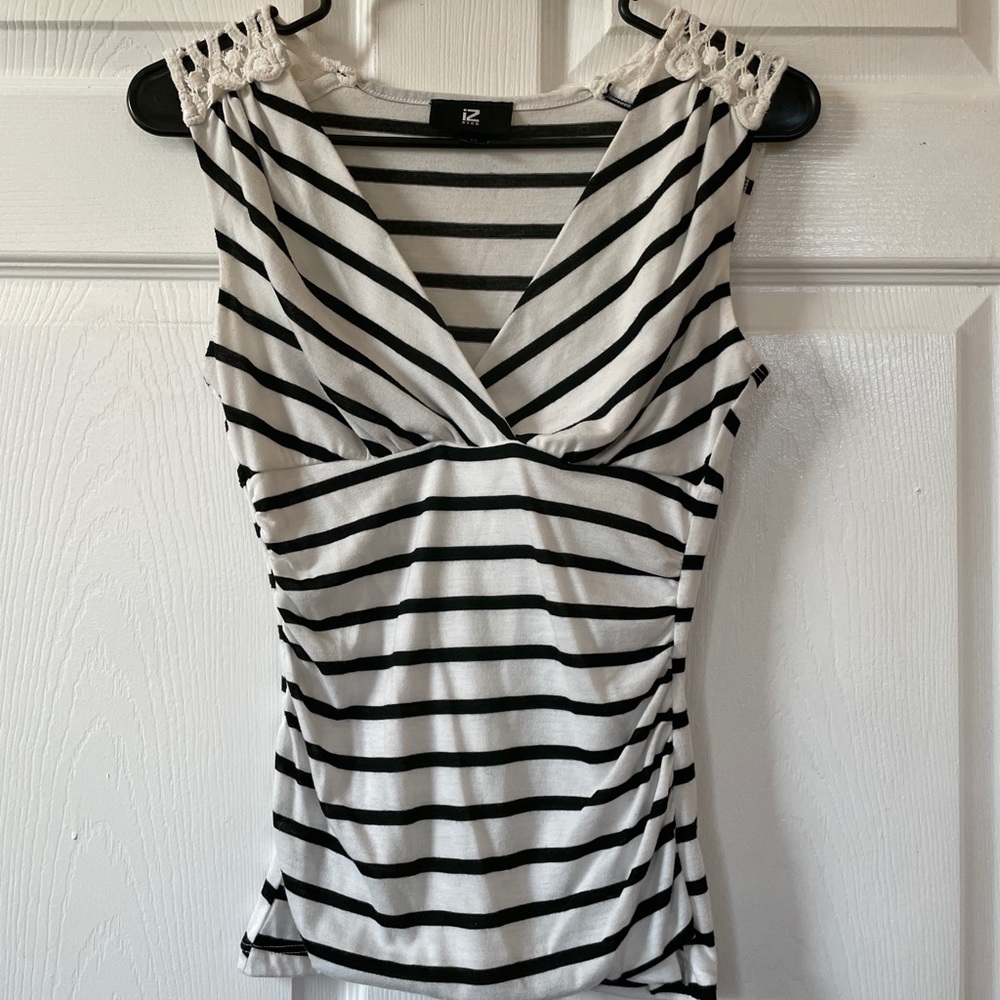 Black and white striped v-neck blouse with lace shoulder detail